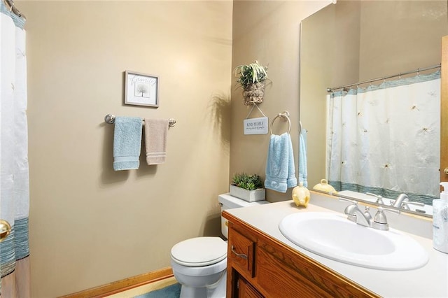 full bathroom featuring vanity, toilet, and curtained shower