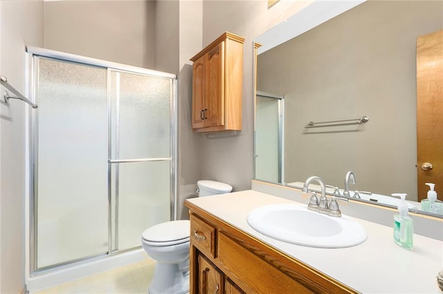 full bath with toilet, a stall shower, and vanity