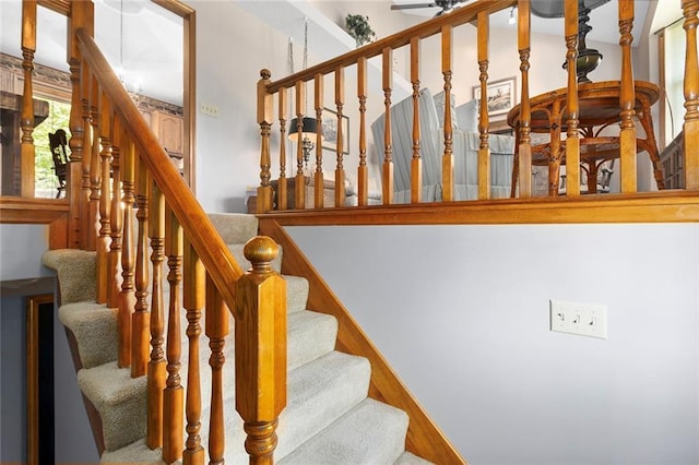 stairway with a ceiling fan