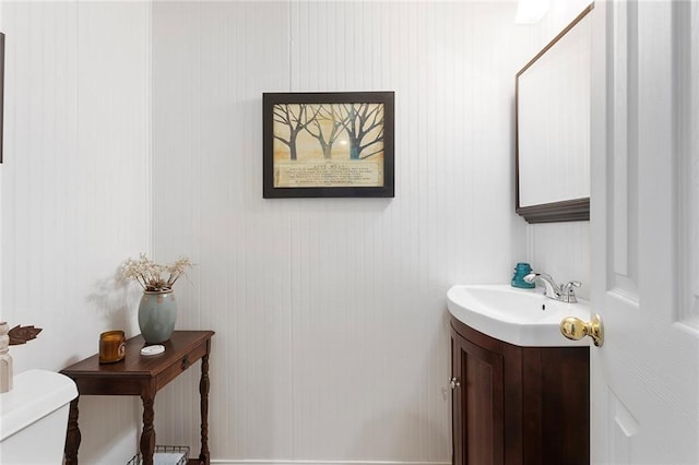 half bath with vanity and toilet