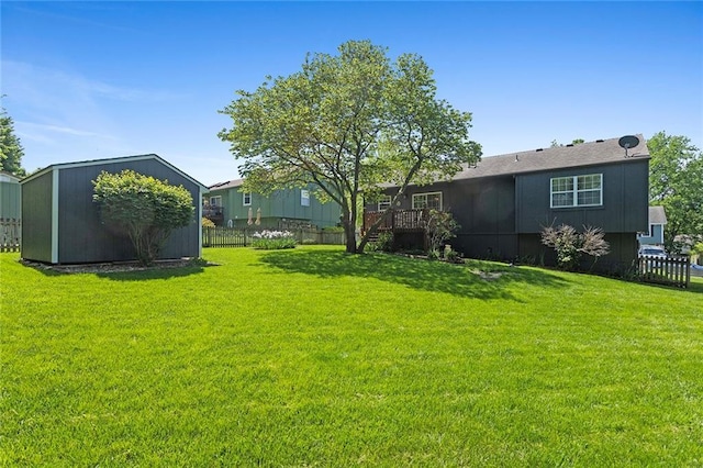 view of yard with a shed, an outdoor structure, and a wooden deck