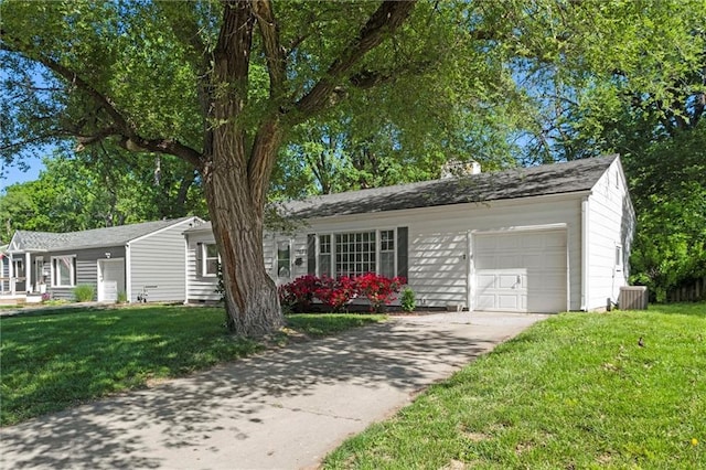 view of front of house with a garage, a front yard, and concrete driveway