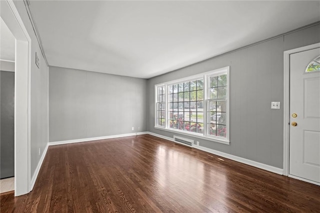 foyer entrance featuring wood finished floors and baseboards