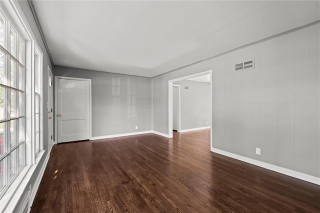 spare room with dark wood finished floors and baseboards