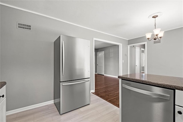 kitchen with stainless steel appliances, a chandelier, baseboards, decorative light fixtures, and light wood-type flooring