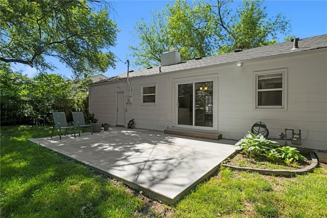 rear view of property featuring a patio area and a lawn