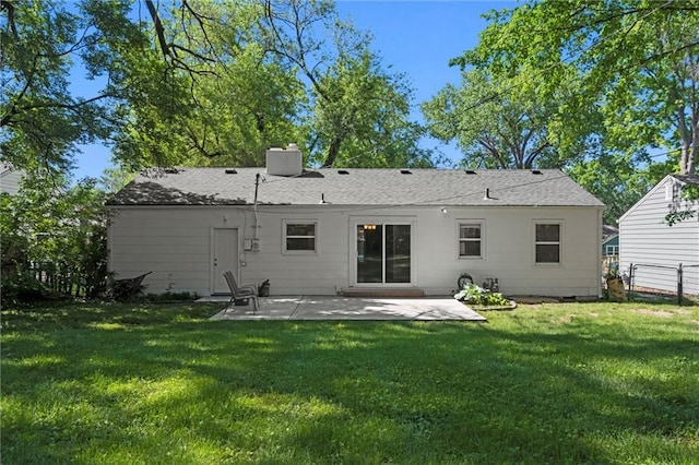 rear view of house with a patio and a chimney