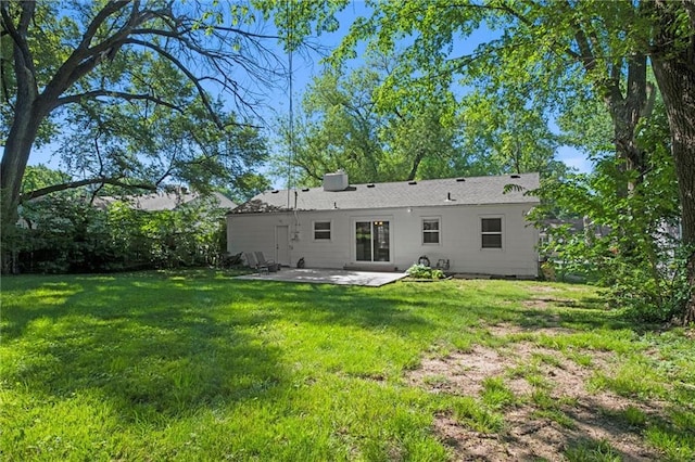 back of property featuring a patio and a lawn