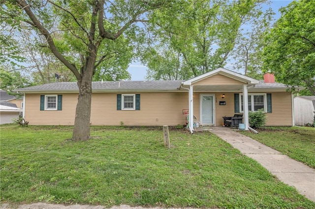 709 E Lincoln St, Iola, KS 66749 - view of front of property with a front lawn and a chimney