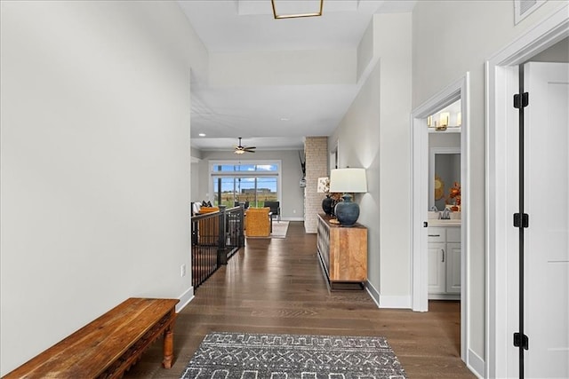 hallway featuring baseboards and wood finished floors