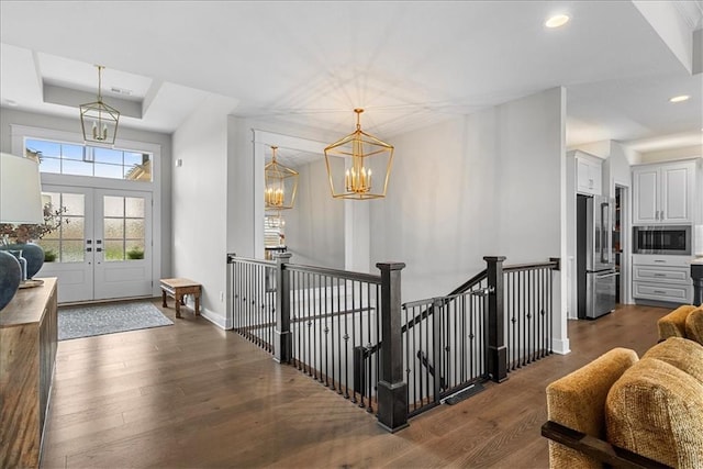 entryway featuring baseboards, dark wood-style floors, recessed lighting, a chandelier, and french doors