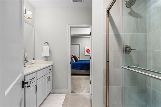 bathroom featuring visible vents, a stall shower, vanity, tile patterned floors, and connected bathroom