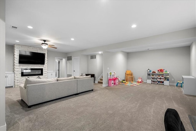 carpeted living room with stairway, a fireplace, a ceiling fan, and recessed lighting