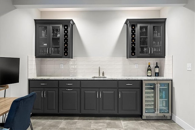 bar with a sink, wet bar, wine cooler, and decorative backsplash