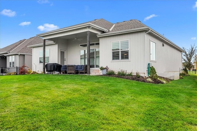 rear view of house with a ceiling fan, outdoor lounge area, fence, and a yard