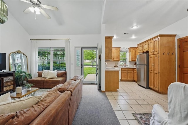 2111 N 83rd Pl, Kansas City, KS 66109 - living area with light tile patterned flooring, a ceiling fan, and vaulted ceiling