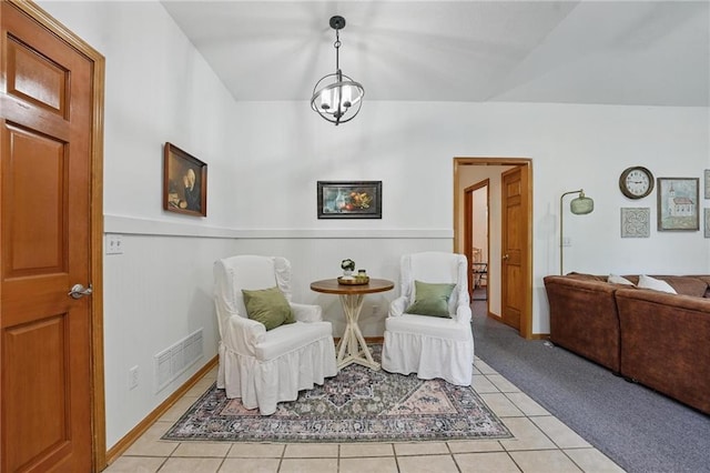 2111 N 83rd Pl, Kansas City, KS 66109 - living area featuring a wainscoted wall, light tile patterned floors, and light colored carpet