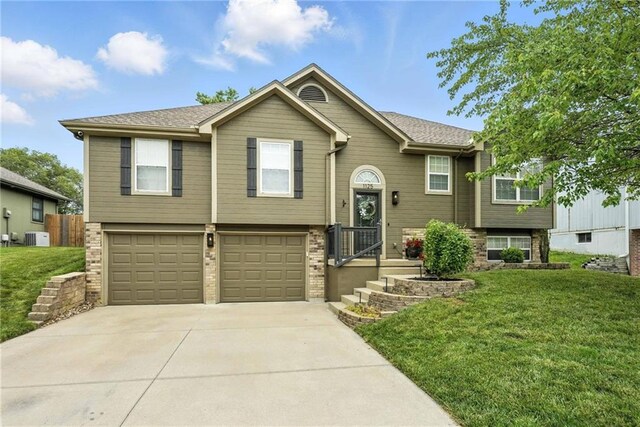 1125 SW Hillcrest Dr, Blue Springs, MO 64015 - split foyer home with driveway, a front lawn, a garage, and brick siding