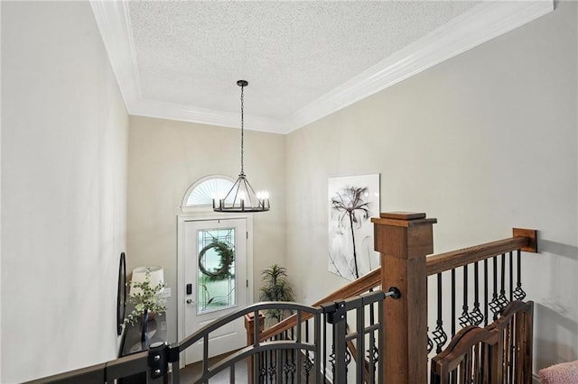 1125 SW Hillcrest Dr, Blue Springs, MO 64015 - entrance foyer featuring crown molding, a chandelier, and a textured ceiling