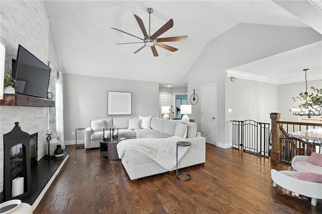 1125 SW Hillcrest Dr, Blue Springs, MO 64015 - living area with ceiling fan, high vaulted ceiling, wood finished floors, a chandelier, and a stone fireplace
