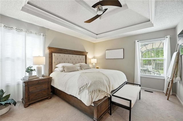 1125 SW Hillcrest Dr, Blue Springs, MO 64015 - bedroom featuring a tray ceiling, light colored carpet, a textured ceiling, and a ceiling fan