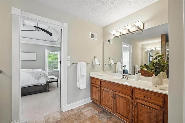 1125 SW Hillcrest Dr, Blue Springs, MO 64015 - bathroom with ensuite bath, vanity, a ceiling fan, a textured ceiling, and stone finish flooring