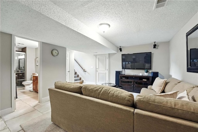 1125 SW Hillcrest Dr, Blue Springs, MO 64015 - living room featuring stairs, light tile patterned floors, and a textured ceiling