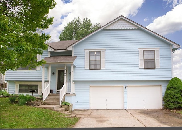 bi-level home with an attached garage and driveway