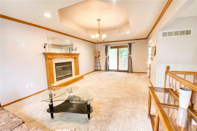 carpeted living area featuring visible vents, an inviting chandelier, a fireplace, baseboards, and a raised ceiling
