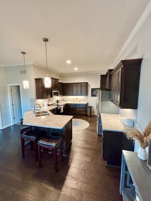 kitchen with a sink, crown molding, and dark brown cabinetry