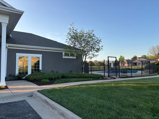 view of yard with fence and a fenced in pool