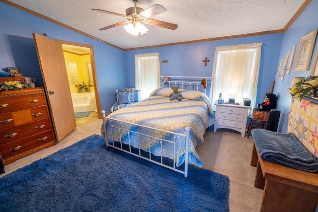 carpeted bedroom with a textured ceiling, ceiling fan, connected bathroom, and ornamental molding