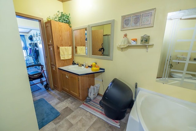 bathroom with vanity and a washtub