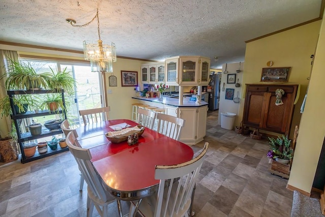dining room featuring crown molding, a textured ceiling, and a chandelier