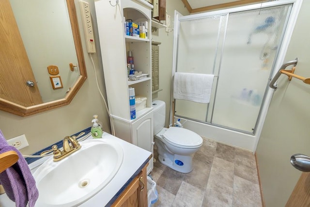 full bath featuring toilet, stone finish floor, and vanity