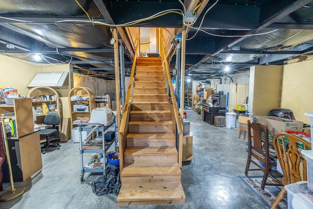 unfinished below grade area featuring stairs