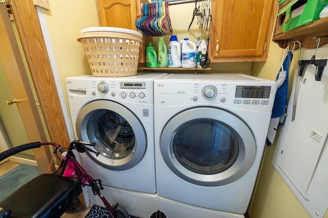 laundry room with washer and clothes dryer and cabinet space