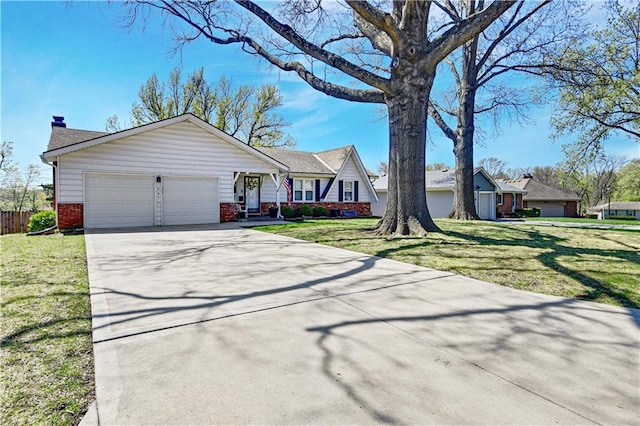 ranch-style home with a front yard, a chimney, brick siding, an attached garage, and driveway
