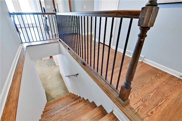 stairs featuring baseboards and wood finished floors