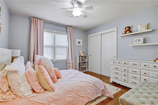 bedroom featuring a ceiling fan, a closet, and dark wood finished floors