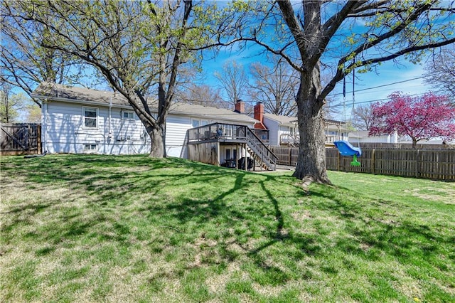 view of yard featuring stairway, a deck, and a fenced backyard