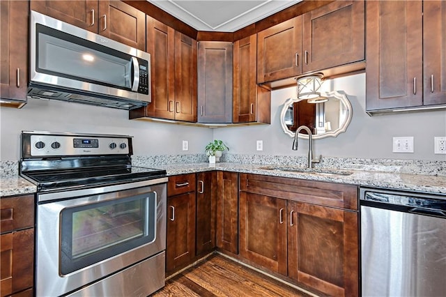 15841 Shawnee Dr, Overland Park, KS 66223 - kitchen featuring stainless steel appliances, a sink, dark wood-type flooring, and light stone counters