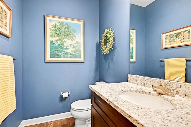 15841 Shawnee Dr, Overland Park, KS 66223 - bathroom with wood finished floors, baseboards, toilet, and vanity