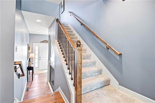 15841 Shawnee Dr, Overland Park, KS 66223 - staircase featuring baseboards, wood finished floors, and recessed lighting