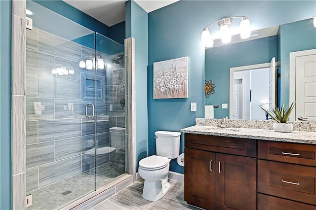 15841 Shawnee Dr, Overland Park, KS 66223 - bathroom with toilet, vanity, a shower stall, and baseboards