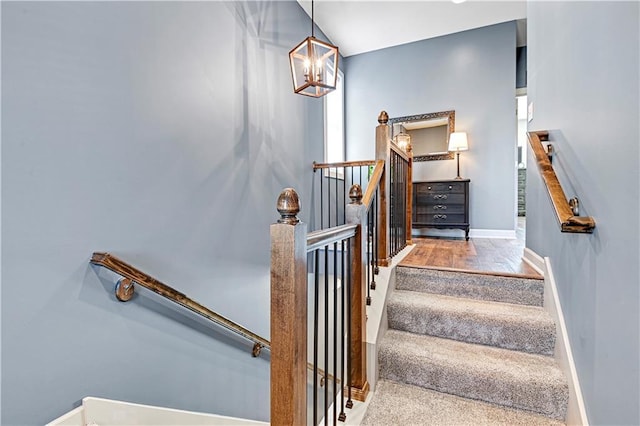 15841 Shawnee Dr, Overland Park, KS 66223 - staircase featuring baseboards, a chandelier, and wood finished floors