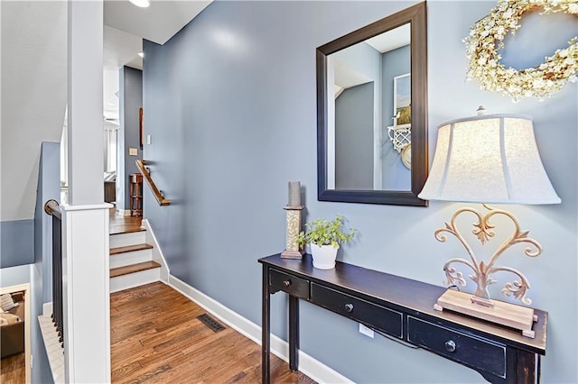 15841 Shawnee Dr, Overland Park, KS 66223 - hallway with wood finished floors, stairs, and baseboards