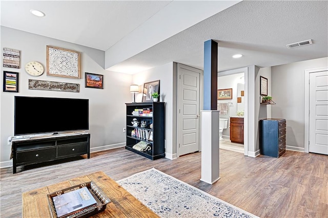 15841 Shawnee Dr, Overland Park, KS 66223 - living area with wood finished floors, baseboards, recessed lighting, and ornate columns