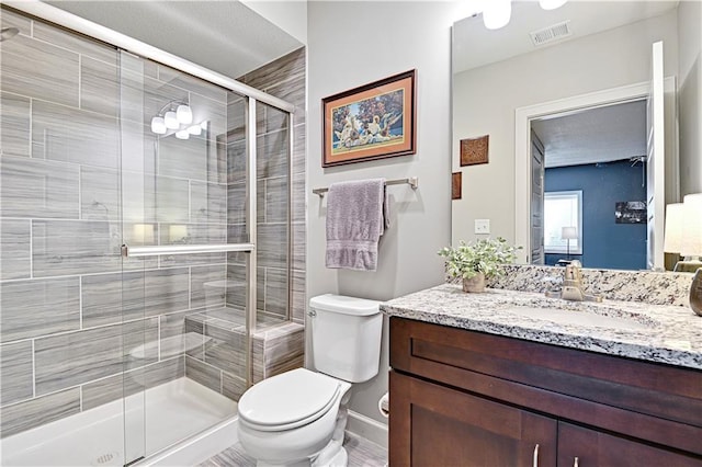 15841 Shawnee Dr, Overland Park, KS 66223 - bathroom with a stall shower, toilet, vanity, and baseboards