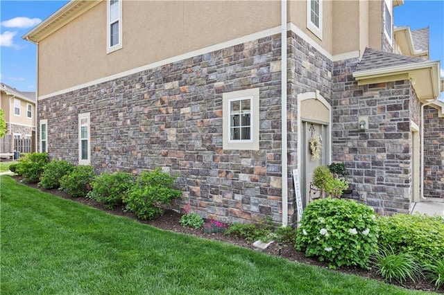 15841 Shawnee Dr, Overland Park, KS 66223 - view of side of property featuring stucco siding, stone siding, and a lawn